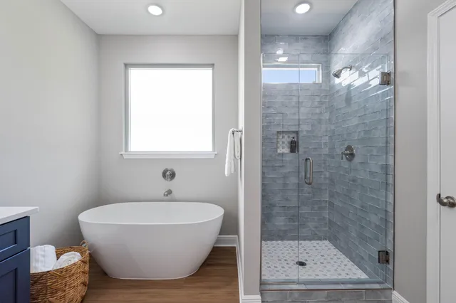 a bathroom with a bathtub and shower