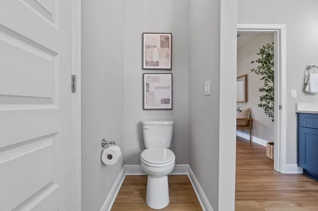 a living room with furniture and a large window with wooden floor