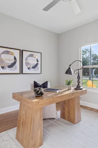 a room that has a table and a vase of flowers