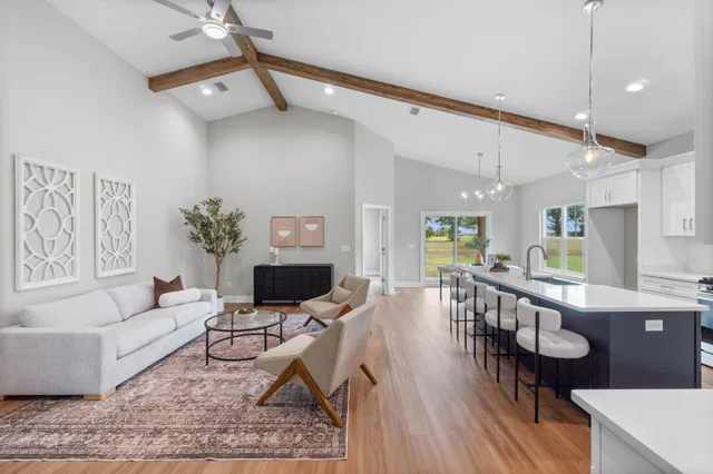 a living room with furniture a table and chair