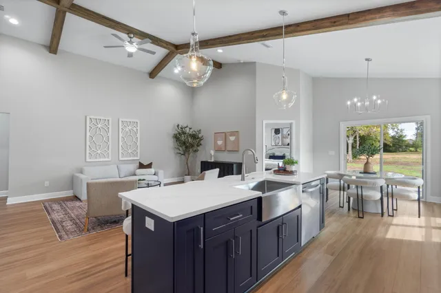 a large kitchen with a table and chairs