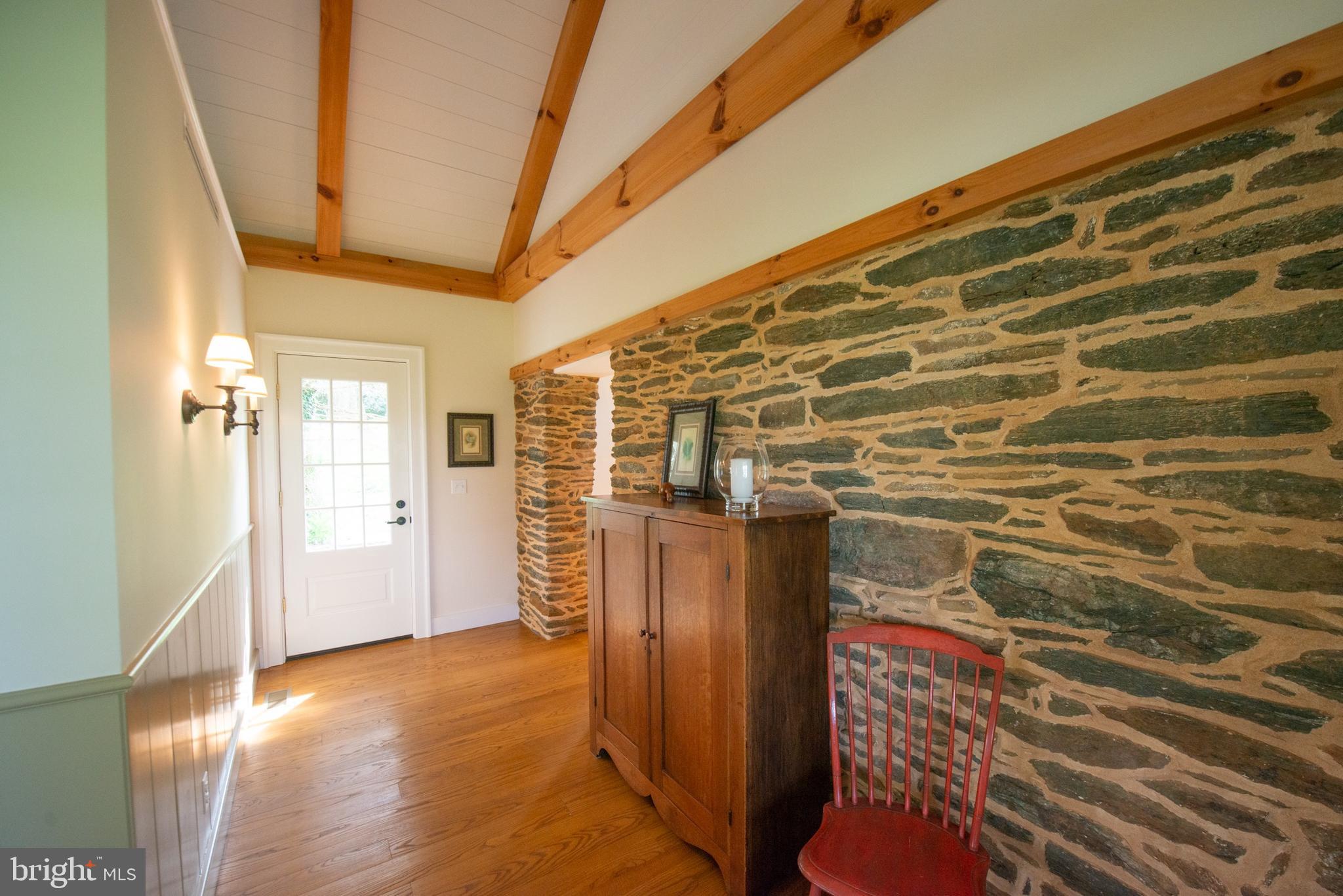 8669 Springs Road Warrenton, VA 20186 - Photo 35 of 50 Hallway with Historic Stone Walls and Back Door