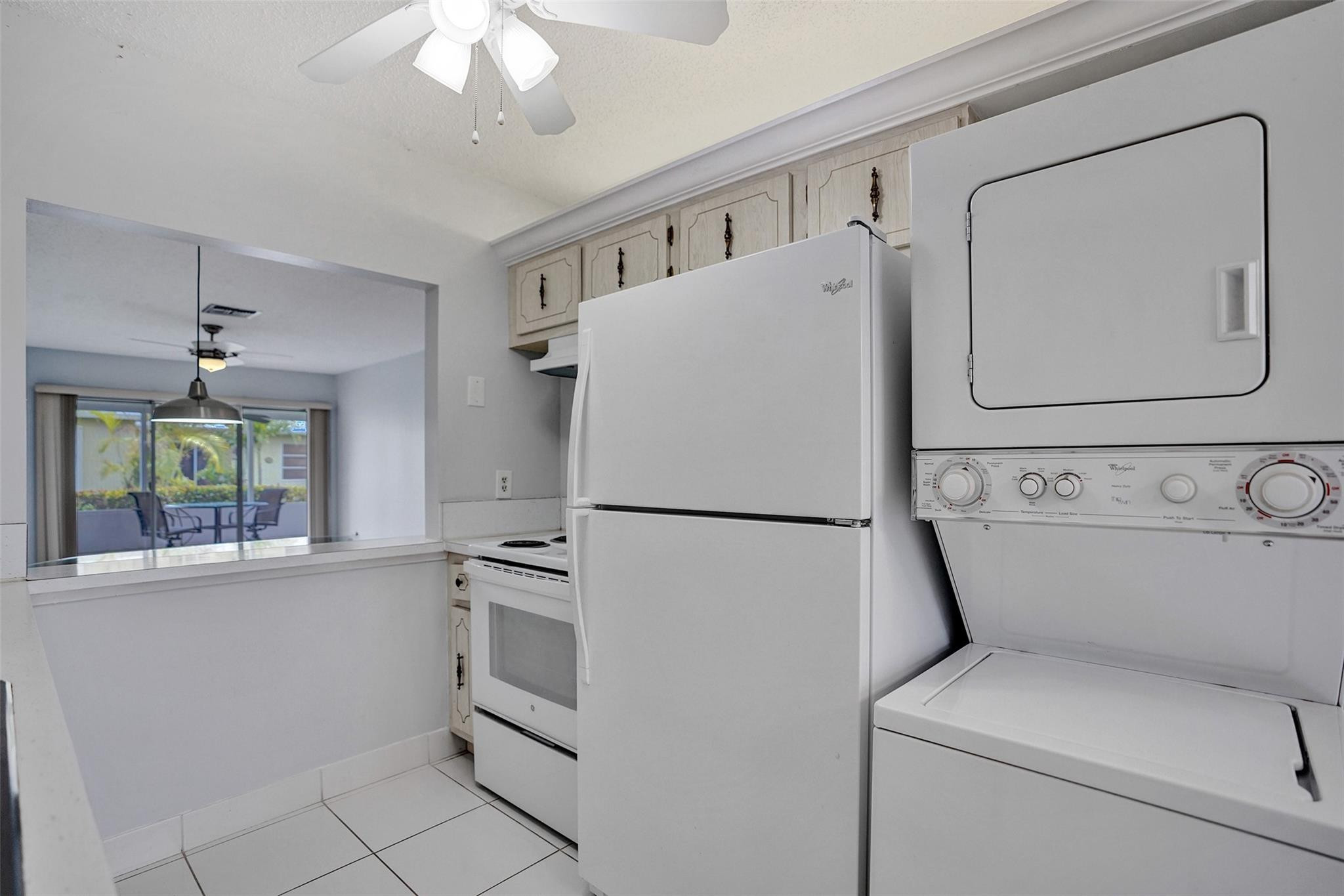 2380 Malayan Drive, Unit B Delray Beach, FL 33445 - Photo 14 of 35 a white refrigerator freezer and a stove sitting inside of a kitchen