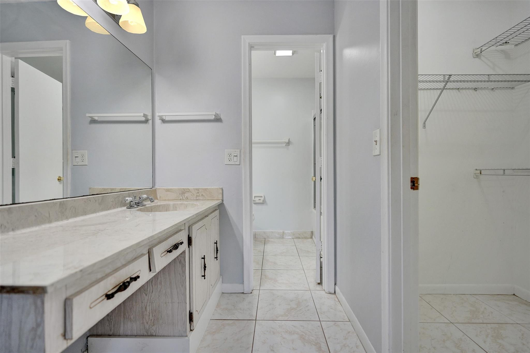 2380 Malayan Drive, Unit B Delray Beach, FL 33445 - Photo 26 of 35 a bathroom with a granite countertop sink a toilet and shower