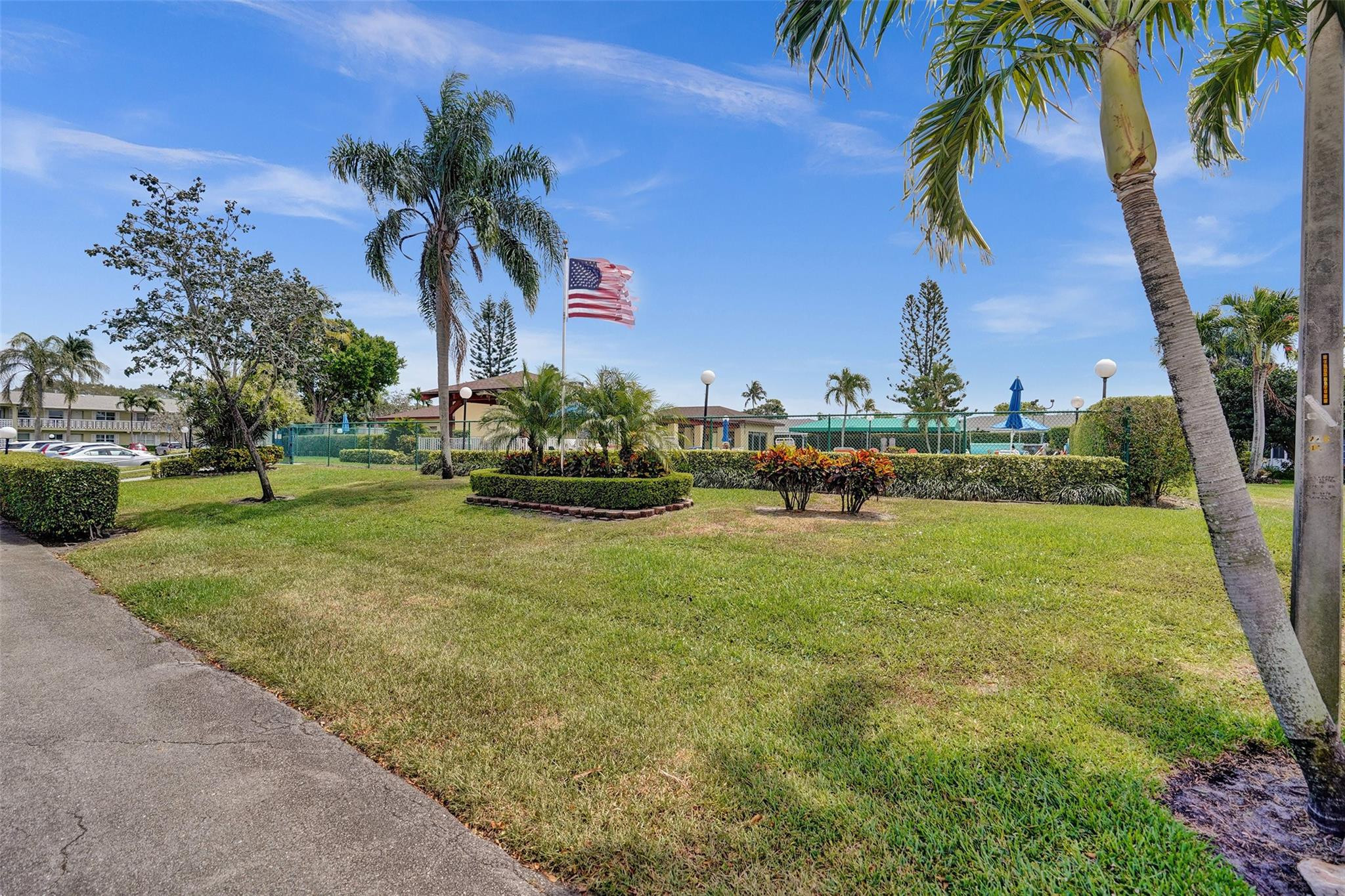 2380 Malayan Drive, Unit B Delray Beach, FL 33445 - Photo 4 of 35 a front view of a house with garden