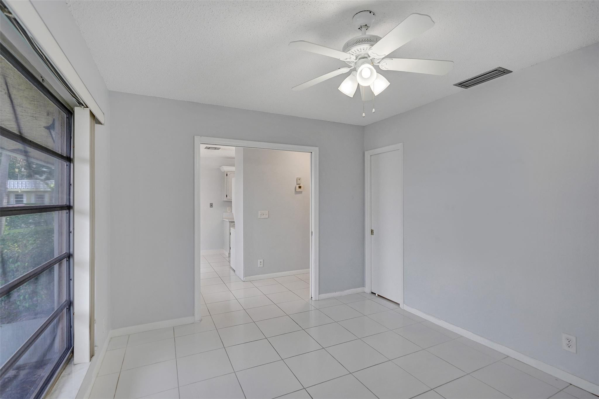 2380 Malayan Drive, Unit B Delray Beach, FL 33445 - Photo 10 of 35 a view of an empty room with a chandelier fan