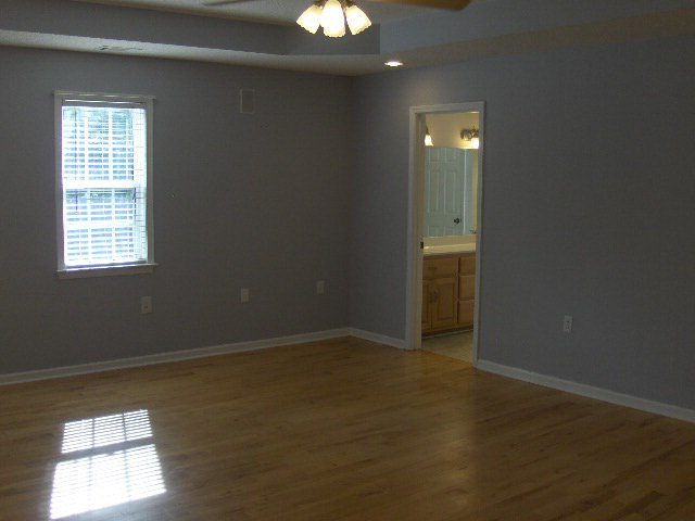 832 Cumslo Road Gray, GA 31032 - Photo 9 of 22 an empty room with wooden floor and windows