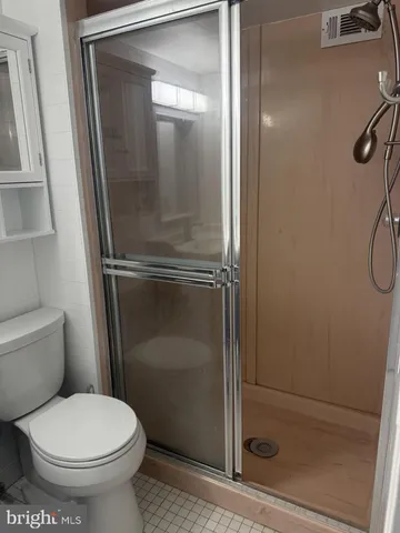 a bathroom with a toilet and a shower