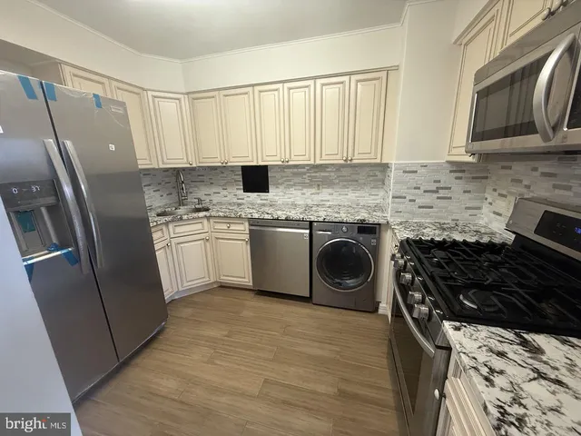 a kitchen with a stove sink and refrigerator