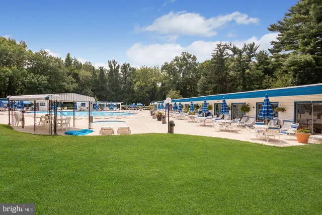 a view of a house with swimming pool and sitting area