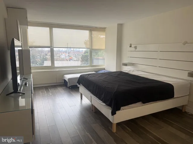 a bedroom with a bed and window