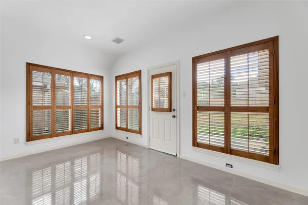 a view of an empty room with a window