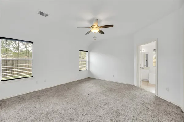 a view of a room with a ceiling fan and a window