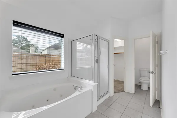 a spacious bathroom with a bathtub and a shower