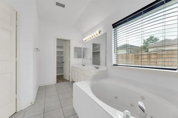 a bathroom with a bathtub and a sink