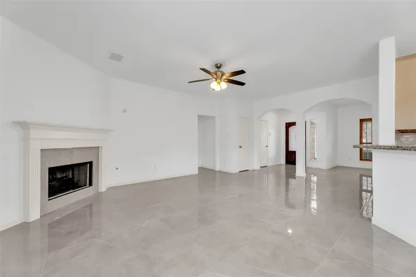a view of an empty room with a fireplace