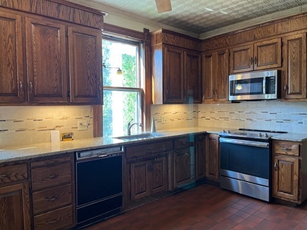 325 Longhill Street Springfield, MA 01108 - Photo 12 of 39 a kitchen with stainless steel appliances granite countertop wooden cabinets a sink and a stove