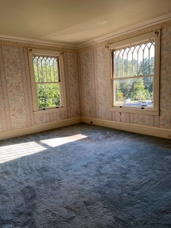 325 Longhill Street Springfield, MA 01108 - Photo 24 of 39 an empty room with wooden floor and windows