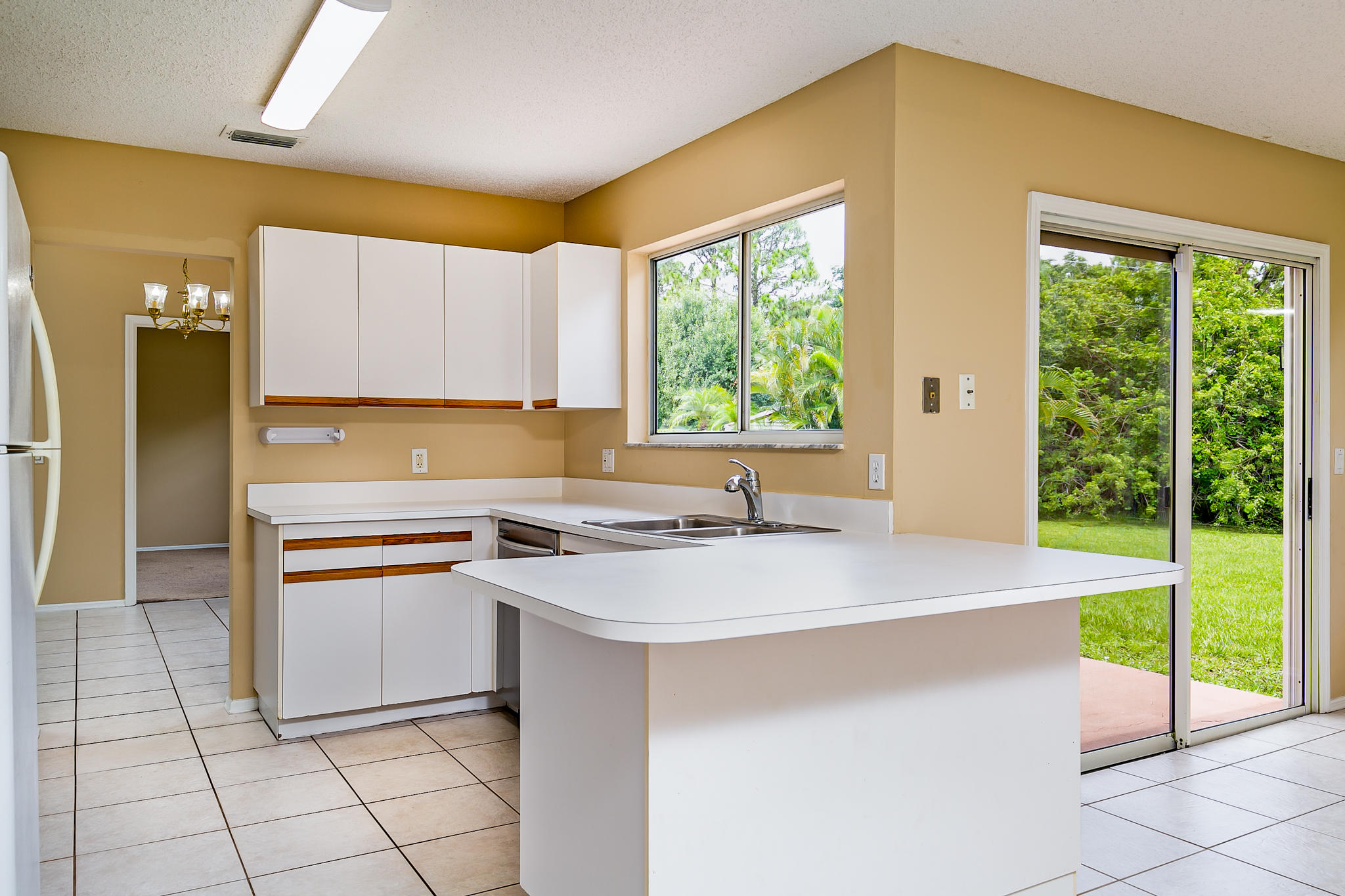 2904 Southeast Bella Road Port St. Lucie, FL 34984 - Photo 12 of 30 a kitchen with a sink a stove and cabinets