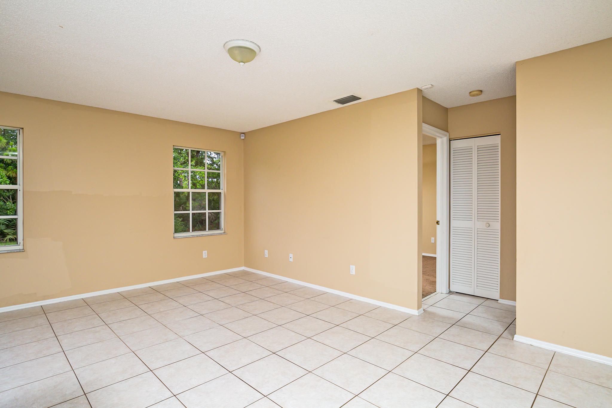 2904 Southeast Bella Road Port St. Lucie, FL 34984 - Photo 16 of 30 a view of an empty room with window and cabinet area