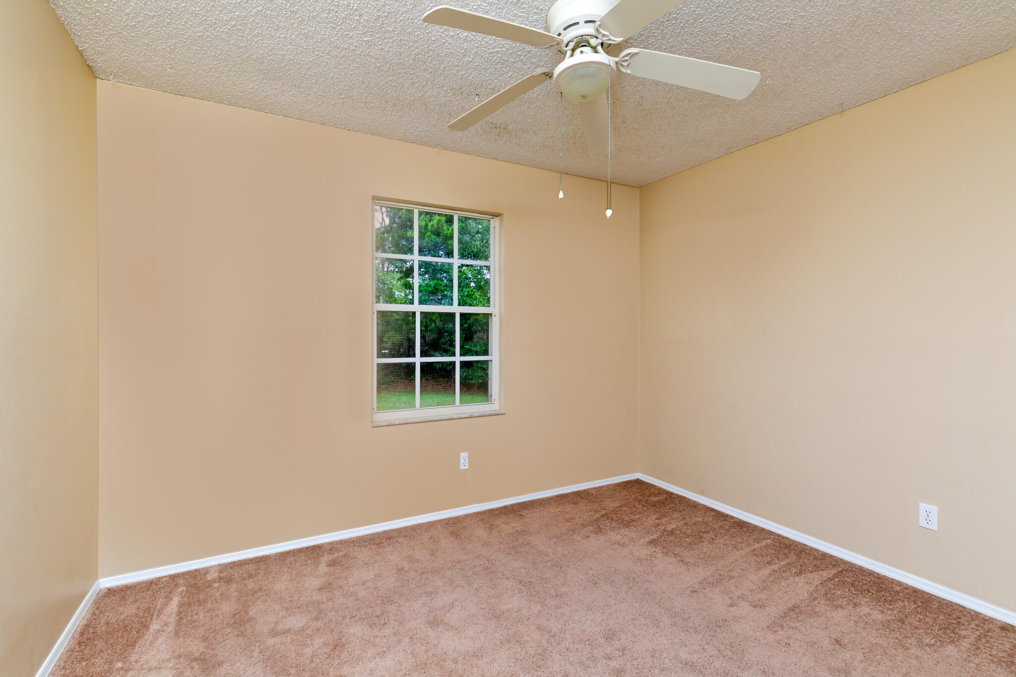 2904 Southeast Bella Road Port St. Lucie, FL 34984 - Photo 17 of 30 an empty room with a window and a fan