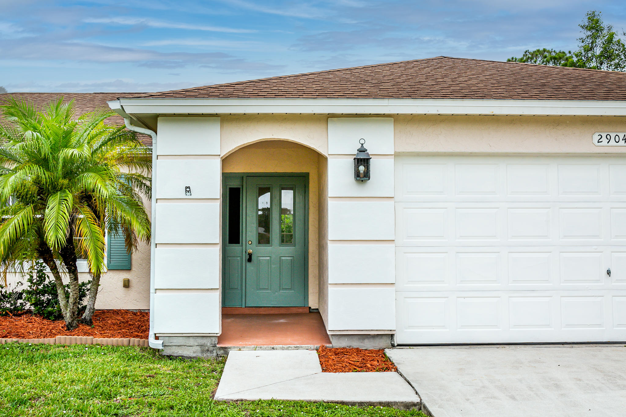 2904 Southeast Bella Road Port St. Lucie, FL 34984 - Photo 2 of 30 a front view of a house with garden