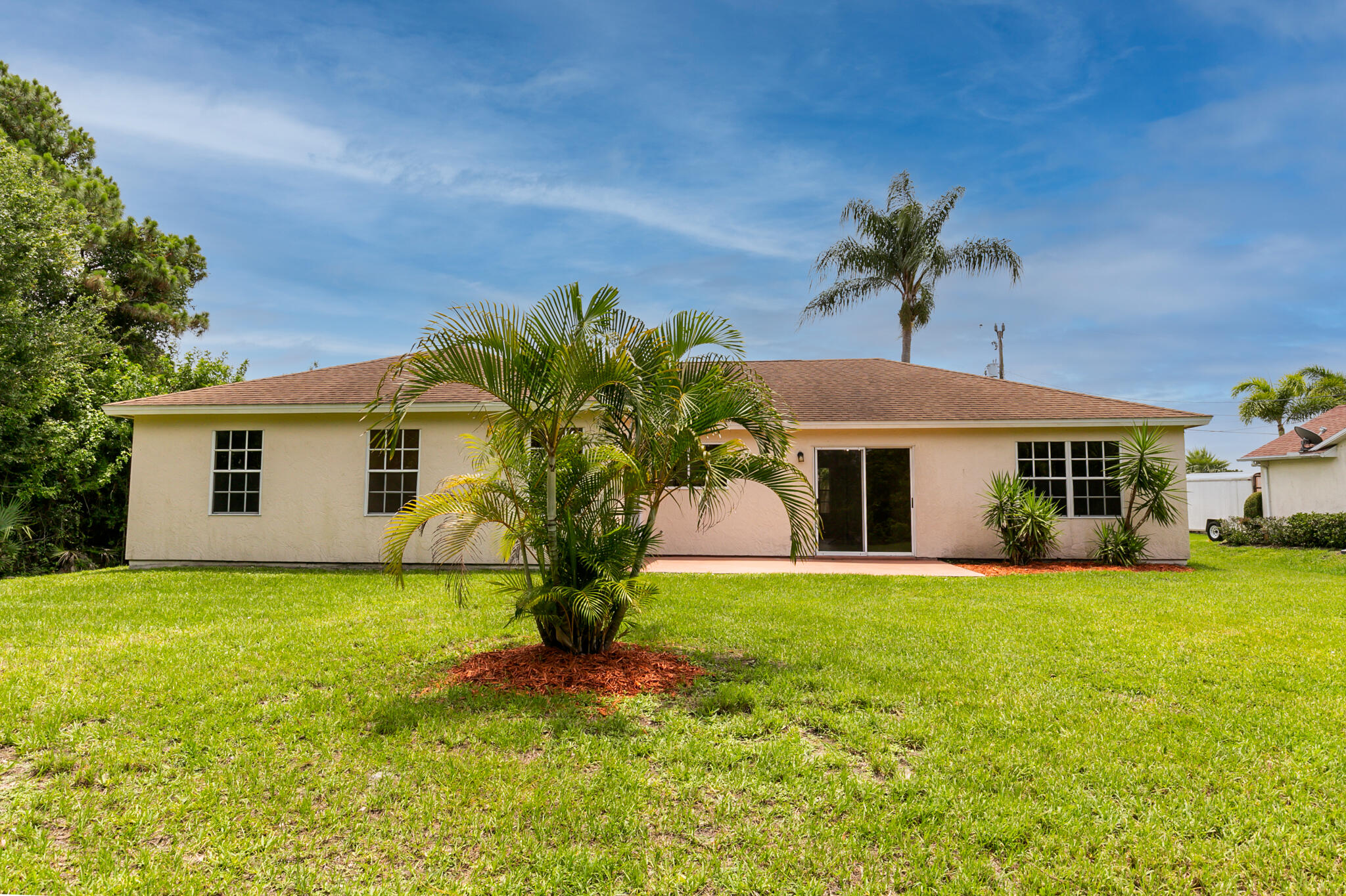 2904 Southeast Bella Road Port St. Lucie, FL 34984 - Photo 26 of 30 a front view of a house with a yard and garage