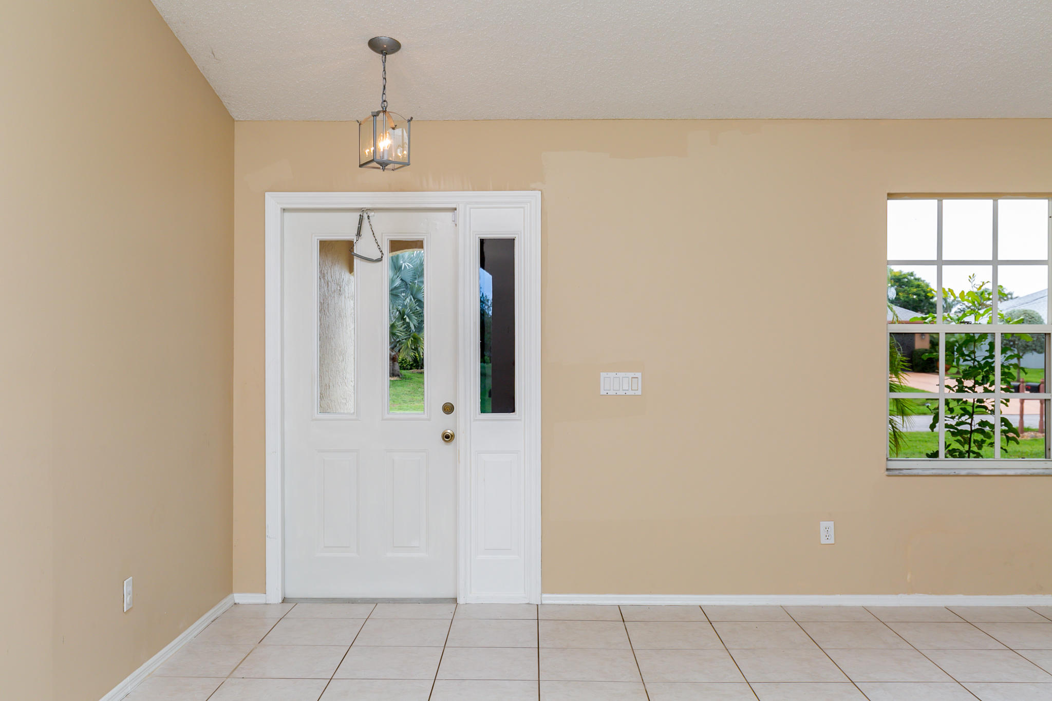2904 Southeast Bella Road Port St. Lucie, FL 34984 - Photo 3 of 30 wooden floor in an empty room with a window