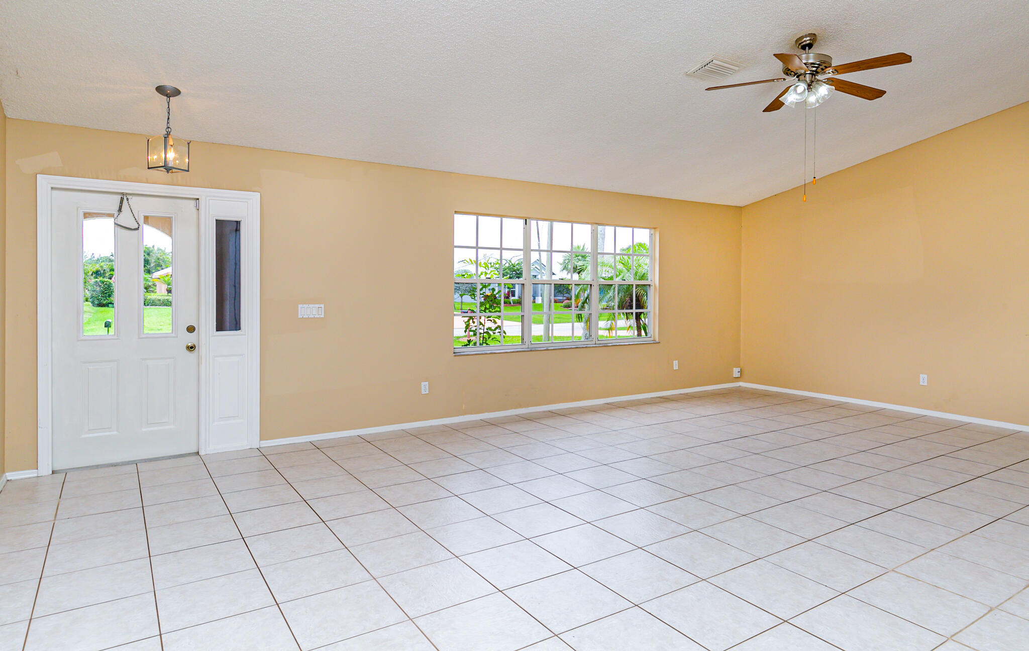 2904 Southeast Bella Road Port St. Lucie, FL 34984 - Photo 4 of 30 an empty room with windows and ceiling fan