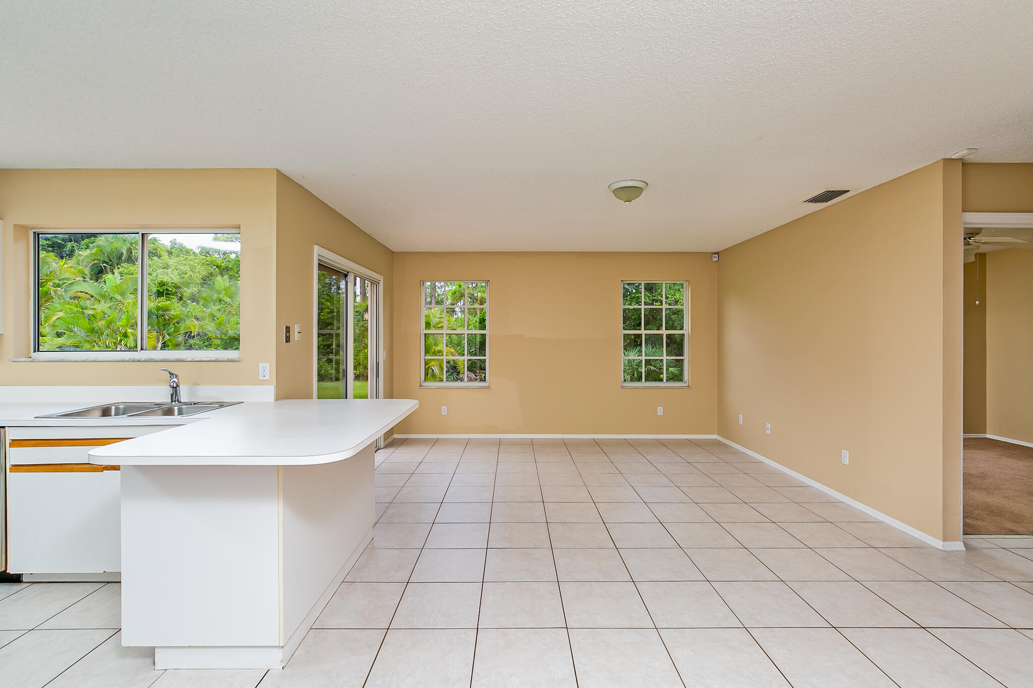 2904 Southeast Bella Road Port St. Lucie, FL 34984 - Photo 10 of 30 a kitchen with stainless steel appliances granite countertop a sink window and cabinets