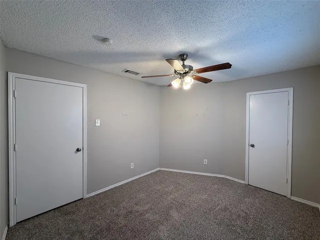 a view of a livingroom with a ceiling fan and a fan