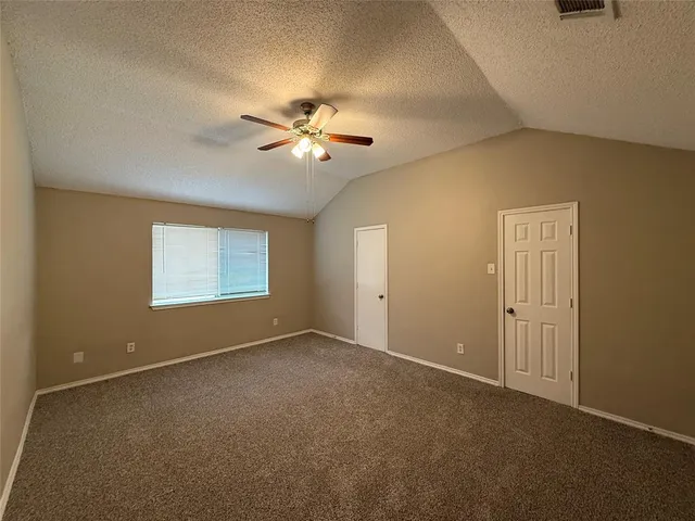 an empty room with a empty space and a ceiling fan
