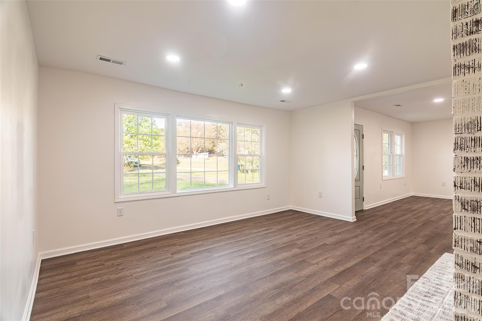 281 Jack McKinney Road Forest City, NC 28043 - Photo 12 of 37 an empty room with wooden floor and windows