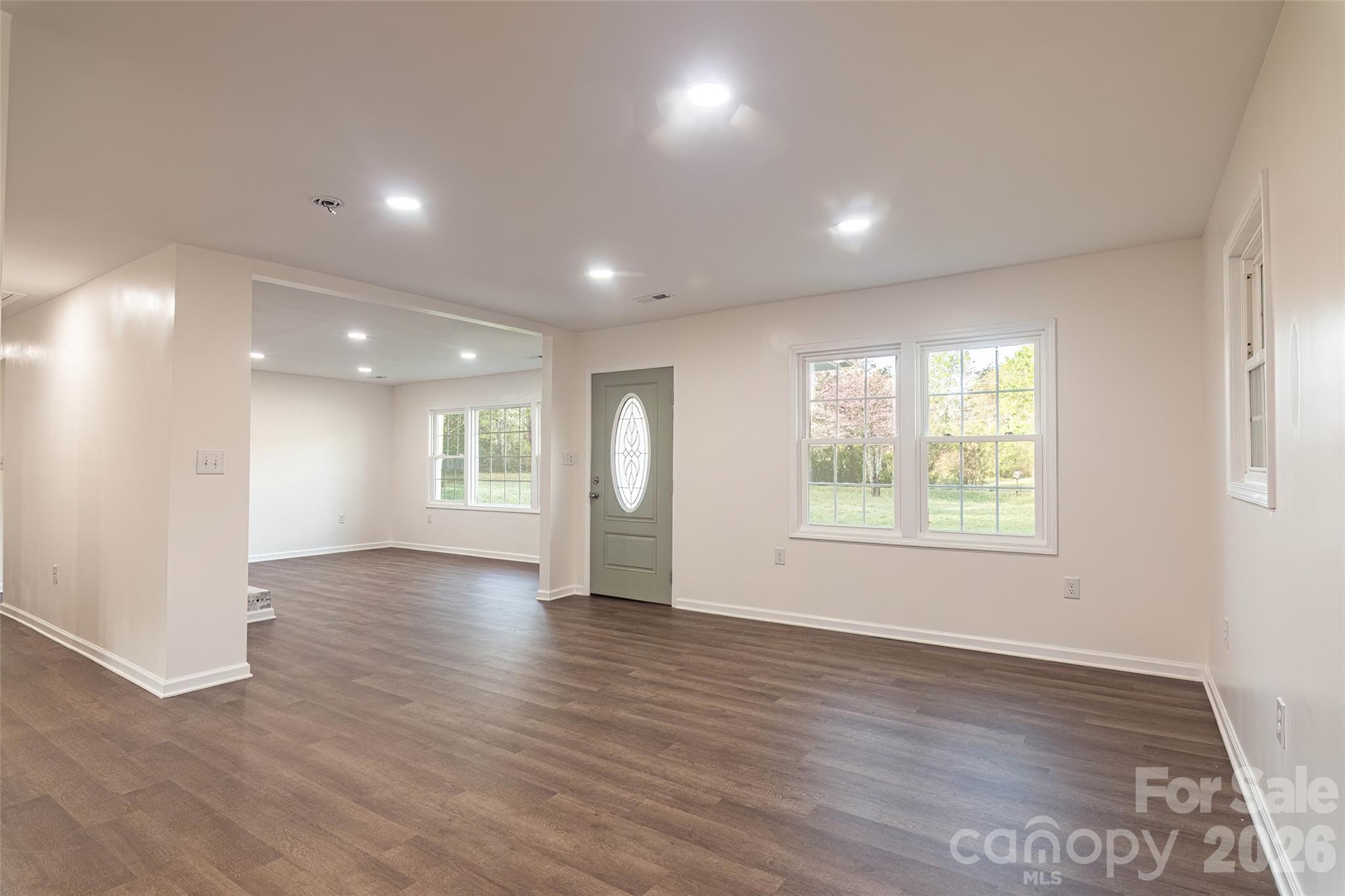 281 Jack McKinney Road Forest City, NC 28043 - Photo 13 of 37 an empty room with wooden floor and windows