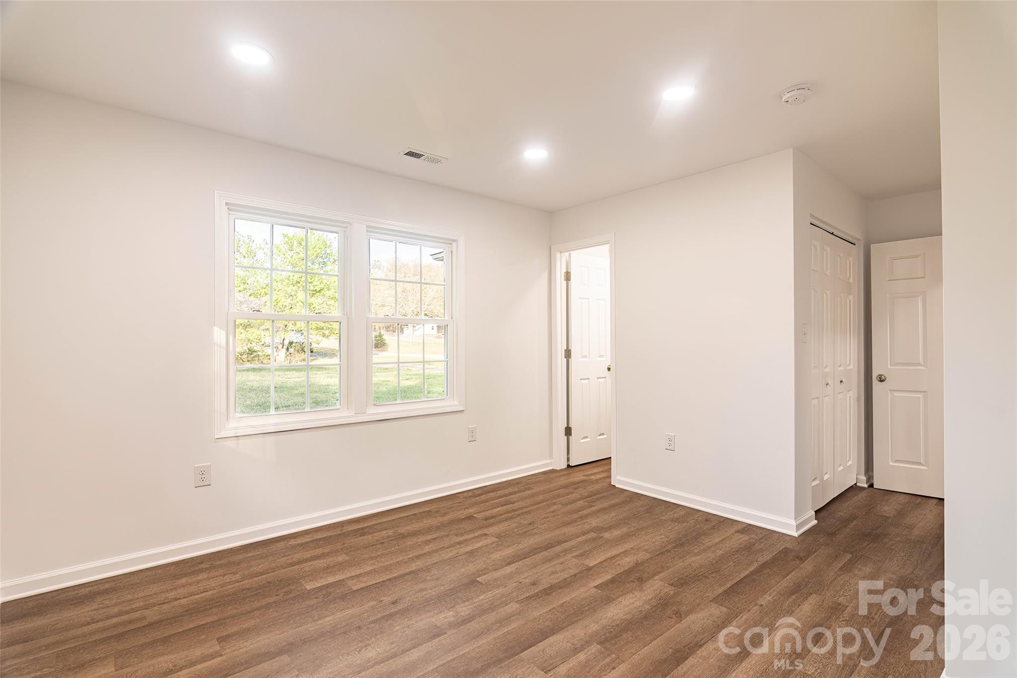 281 Jack McKinney Road Forest City, NC 28043 - Photo 18 of 37 an empty room with wooden floor and windows