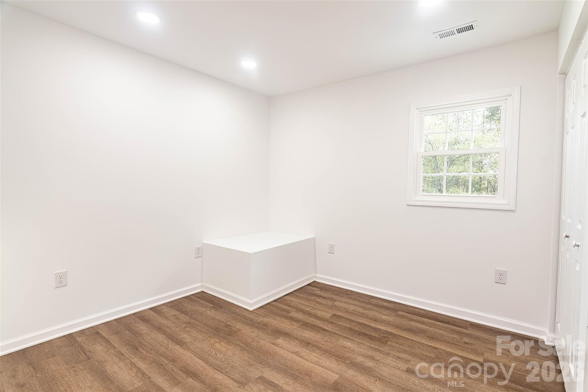 281 Jack McKinney Road Forest City, NC 28043 - Photo 19 of 37 an empty room with wooden floor and windows