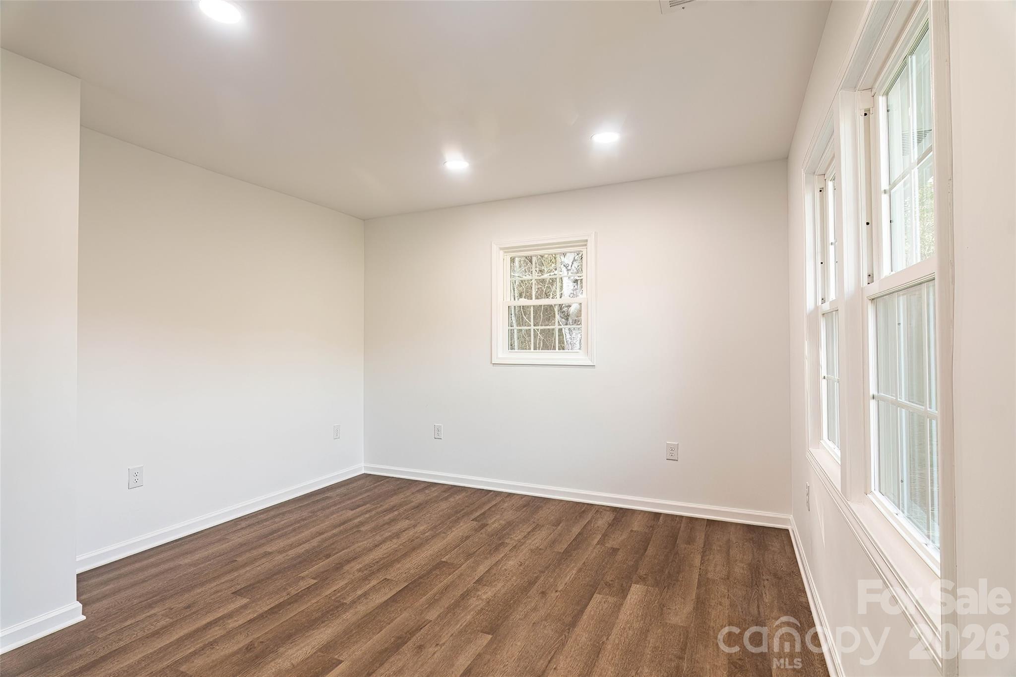 281 Jack McKinney Road Forest City, NC 28043 - Photo 21 of 37 an empty room with wooden floor and windows