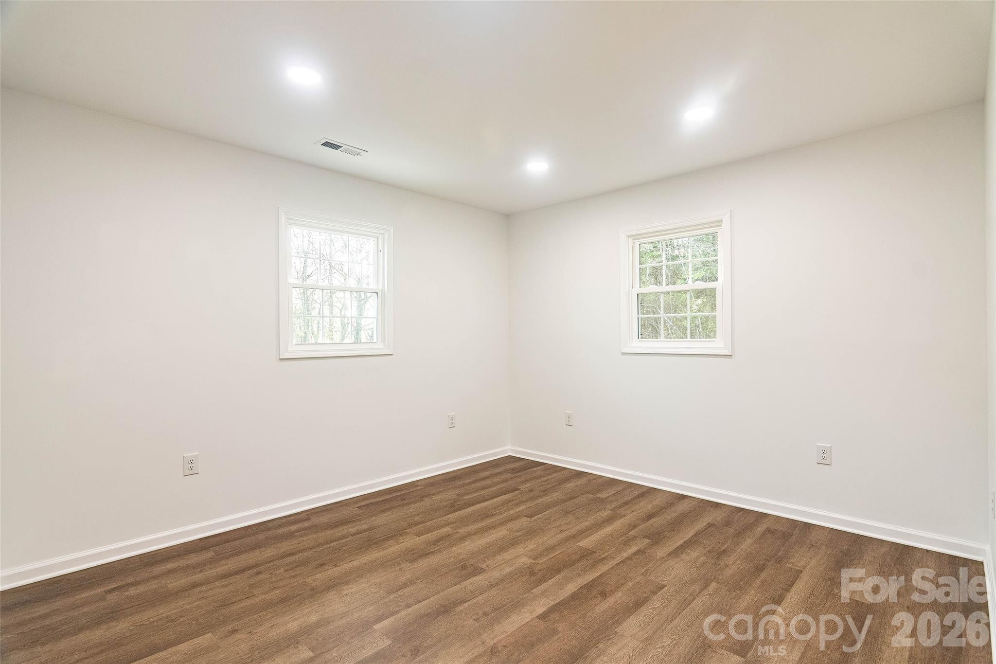 281 Jack McKinney Road Forest City, NC 28043 - Photo 22 of 37 an empty room with wooden floor and windows