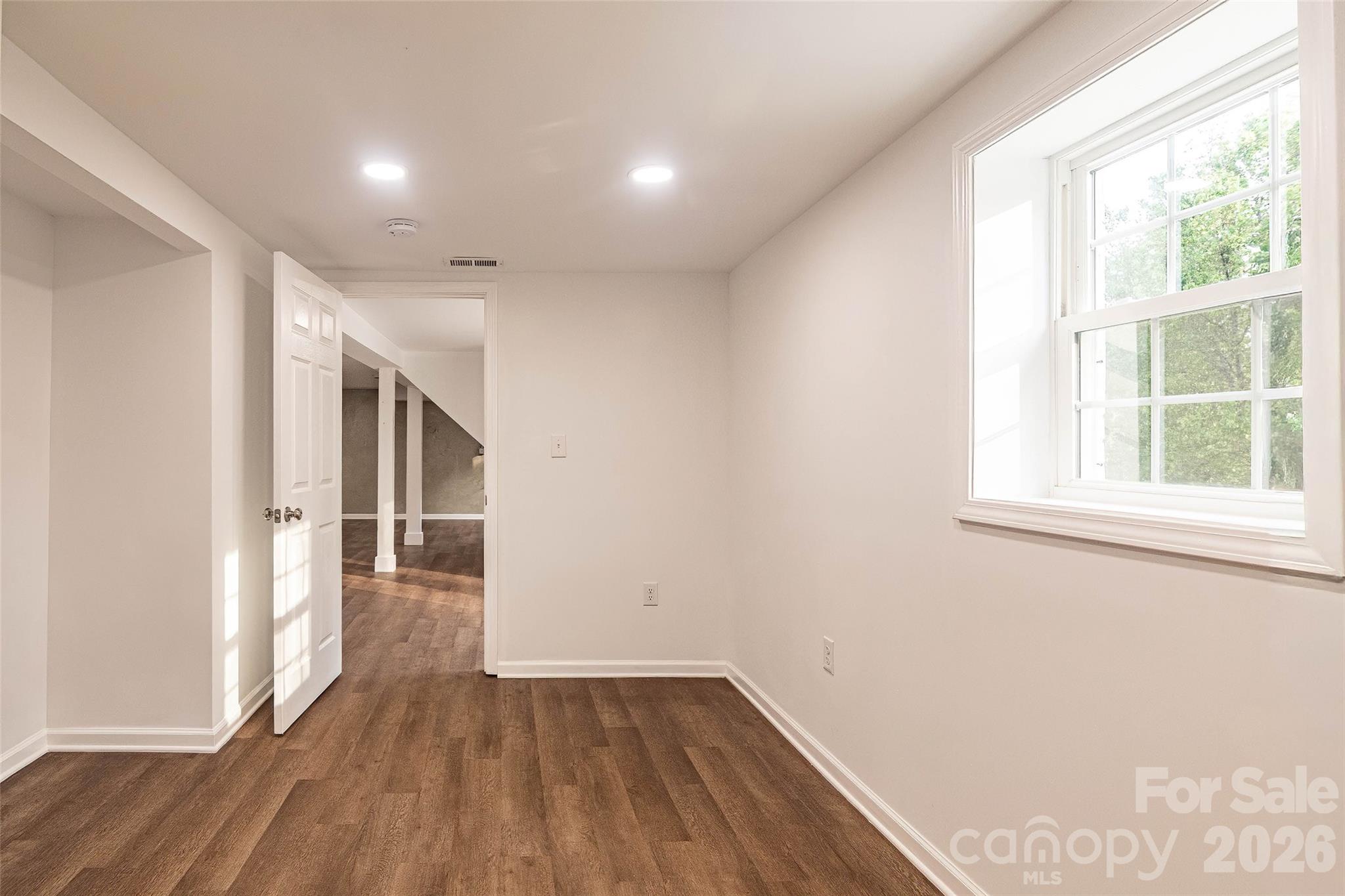 281 Jack McKinney Road Forest City, NC 28043 - Photo 30 of 37 an empty room with wooden floor and windows