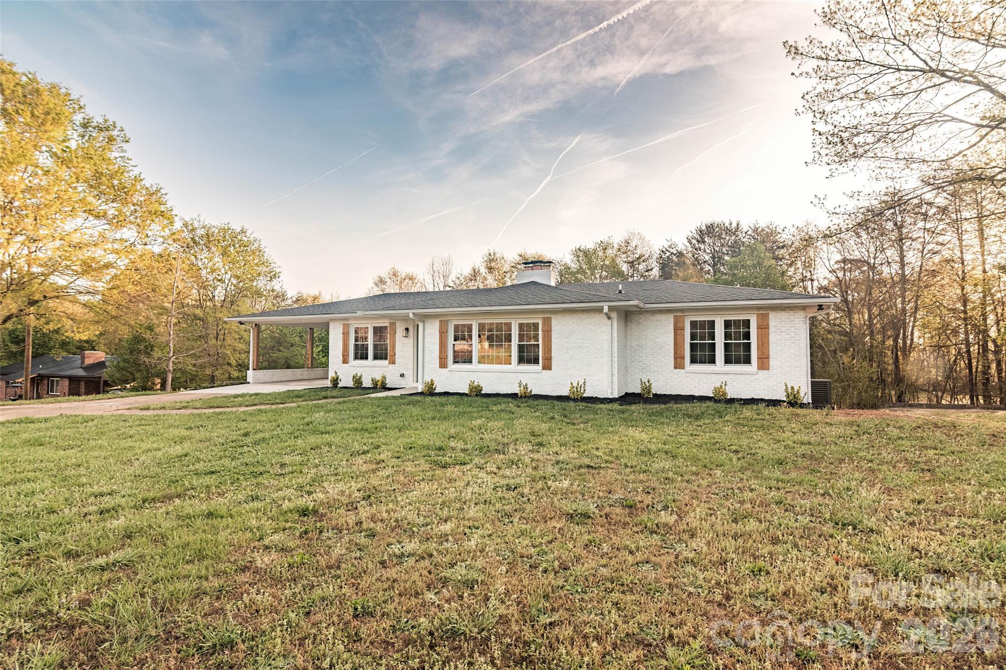 281 Jack McKinney Road Forest City, NC 28043 - Photo 4 of 37 a front view of a house with a garden