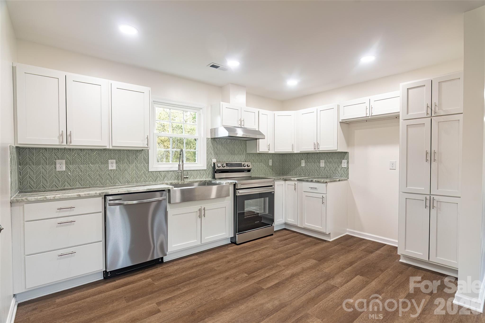 281 Jack McKinney Road Forest City, NC 28043 - Photo 8 of 37 a kitchen with white cabinets and white appliances