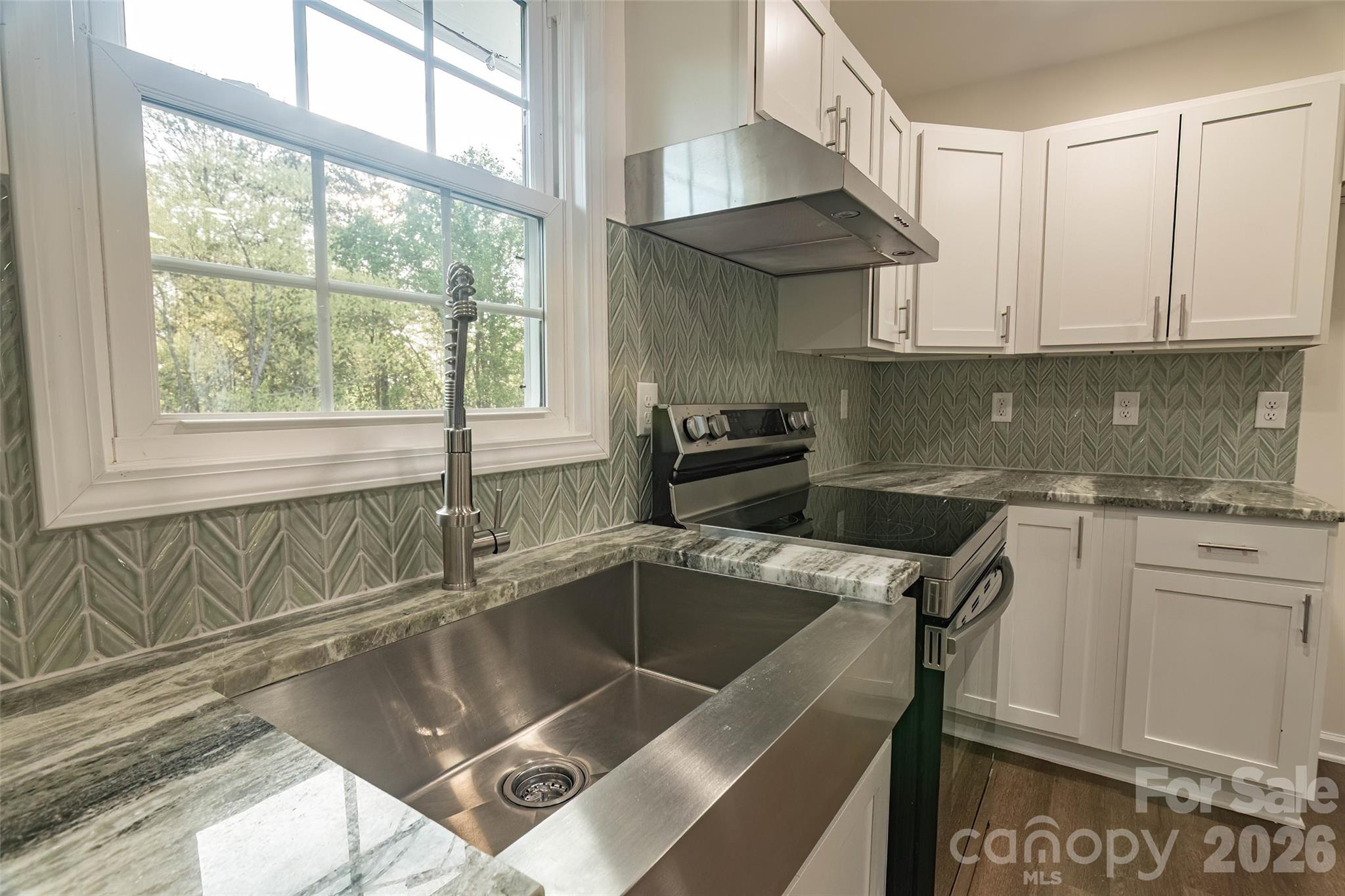 281 Jack McKinney Road Forest City, NC 28043 - Photo 9 of 37 a kitchen with a sink cabinets and window
