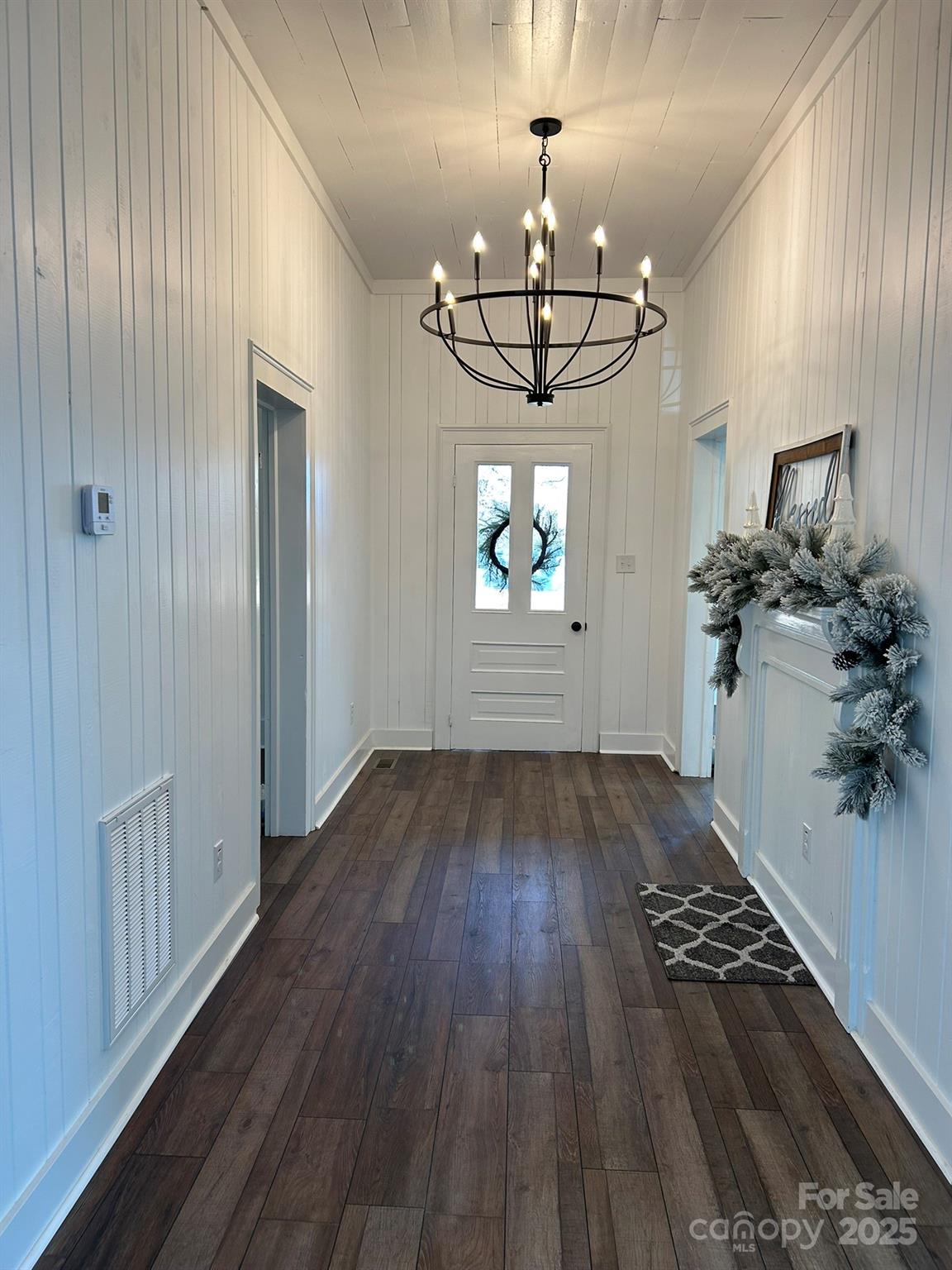 464 Hamrick Road Mooresboro, NC 28114 - Photo 15 of 48 a view of a room with wooden floor chandeliers and kitchen view