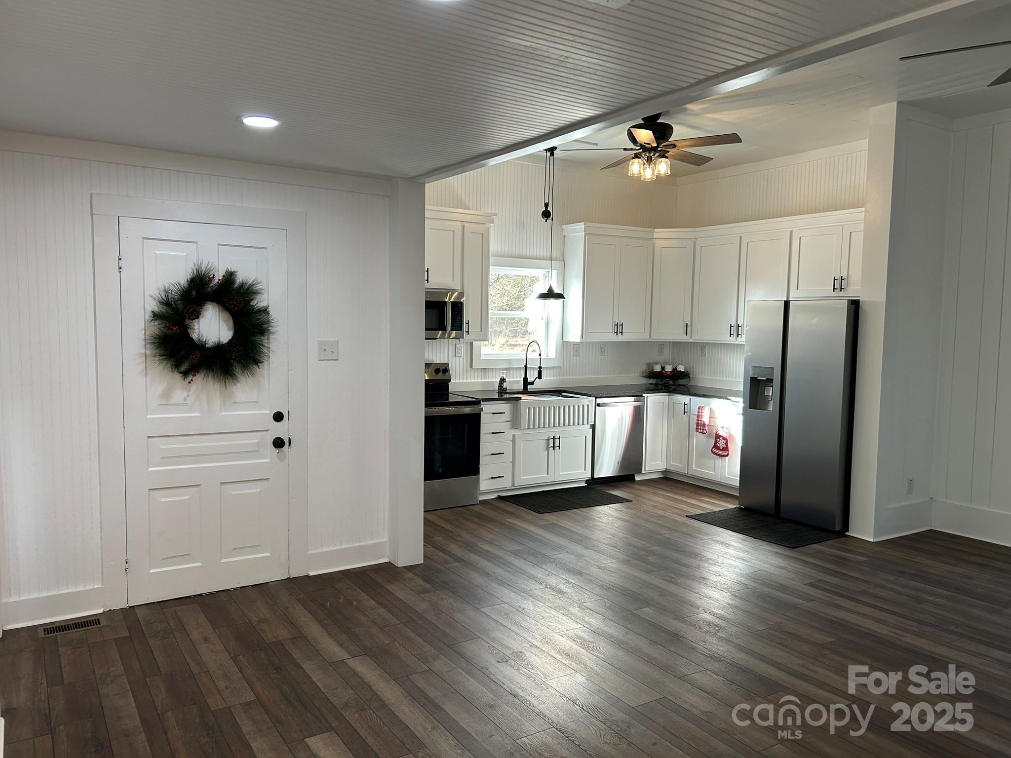 464 Hamrick Road Mooresboro, NC 28114 - Photo 19 of 48 a kitchen with stainless steel appliances a refrigerator cabinets and wooden floor