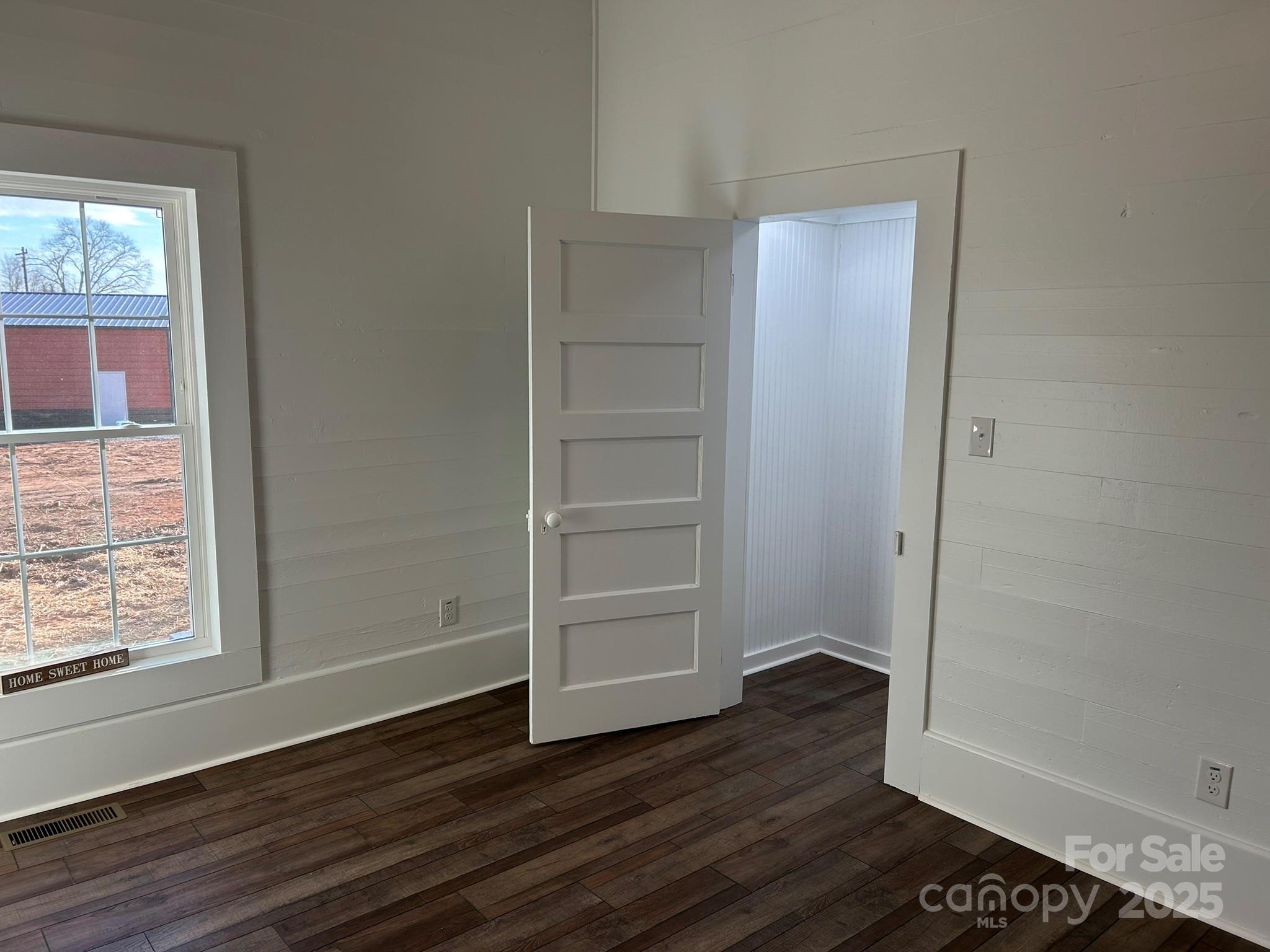 464 Hamrick Road Mooresboro, NC 28114 - Photo 31 of 48 a view of an empty room with wooden floor and a window
