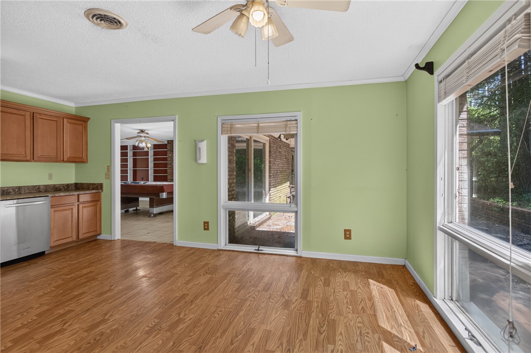 123 Robin Road Westminster, SC 29693 - Photo 21 of 50 A well-lit kitchen area with wood flooring provides an inviting space for culinary endeavors and casual dining.