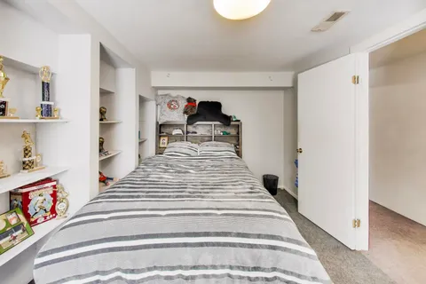 a bed room with a bed and a window