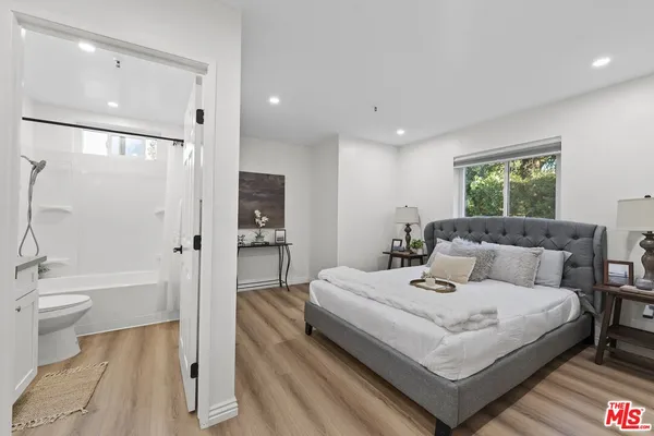 a bedroom with furniture and a table