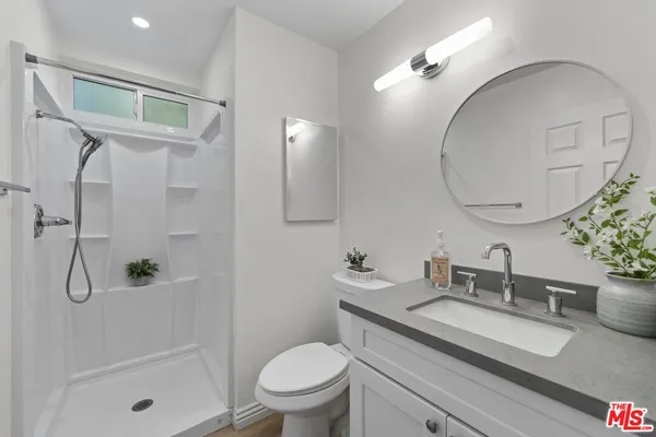 a bathroom with a glass shower door