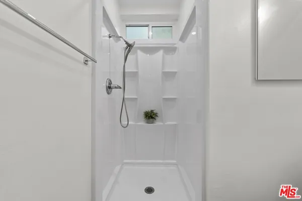 a view of a hallway with washer and dryer